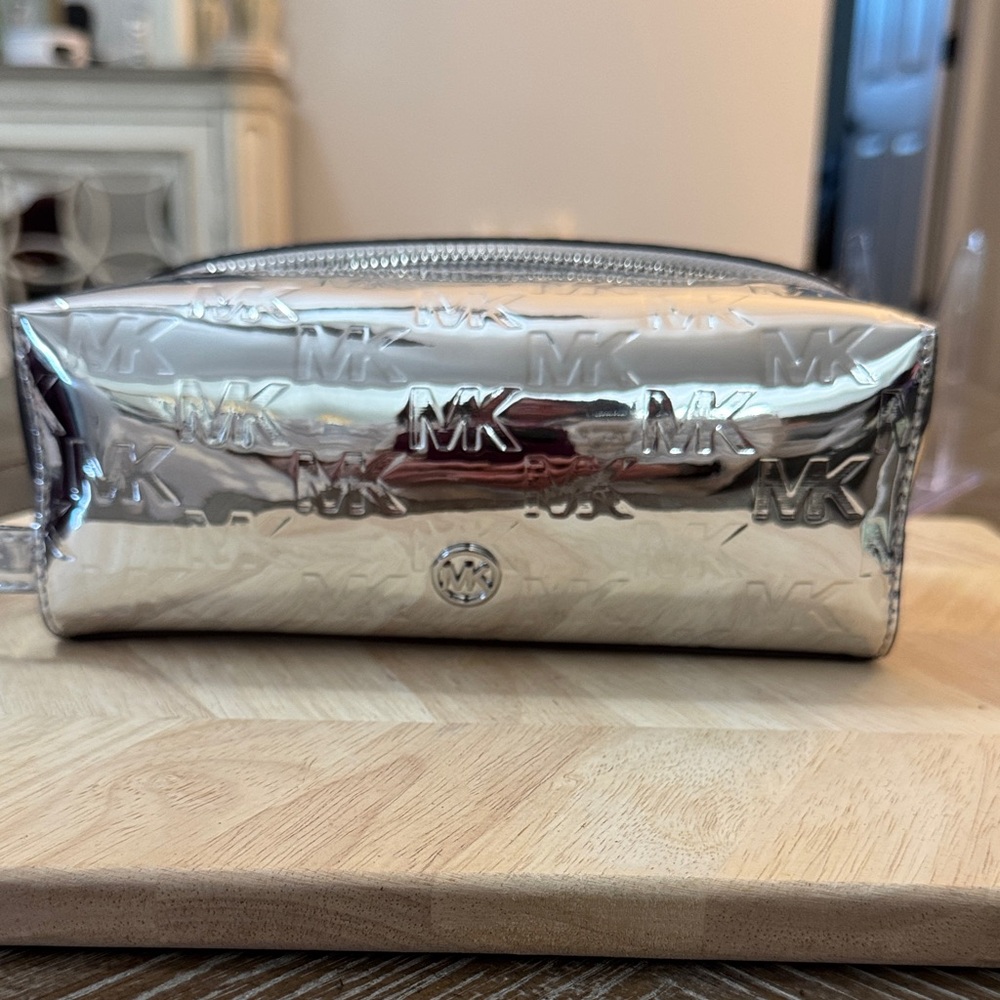 Michael Kors Jet Set Large Metallic Logo Debossed Travel Kit in silver.